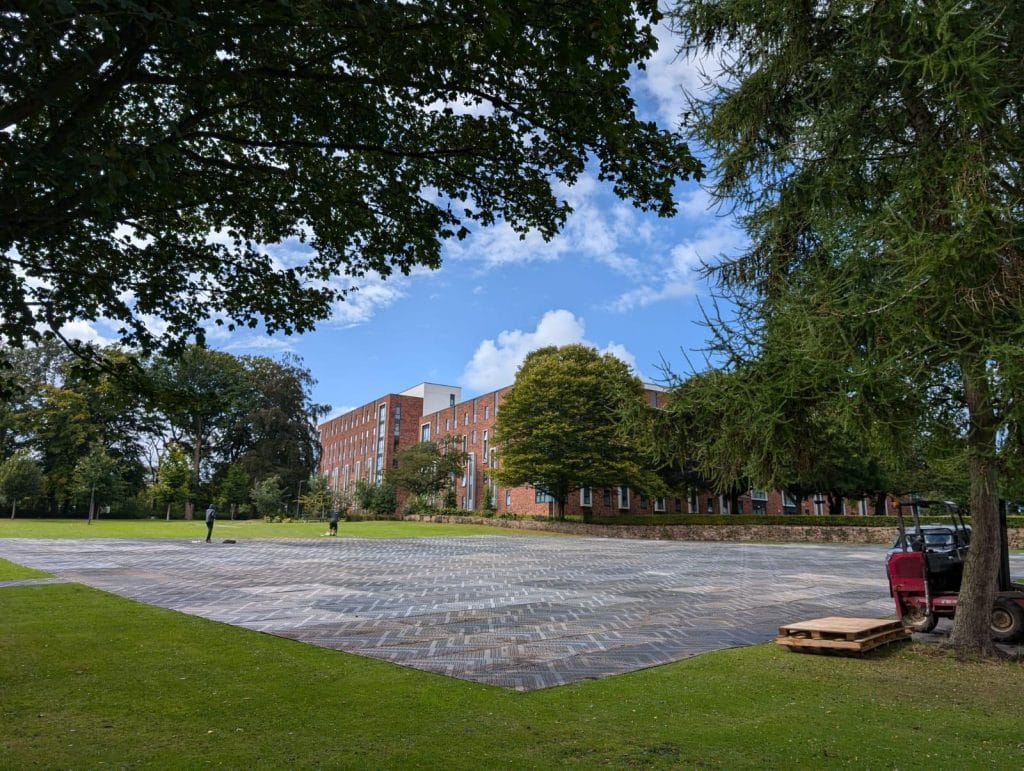 temporary ground protection mats laid over a large lawn