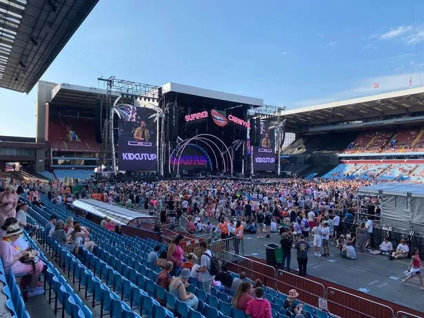 A large crowd on protective ground protection mats at a concert.